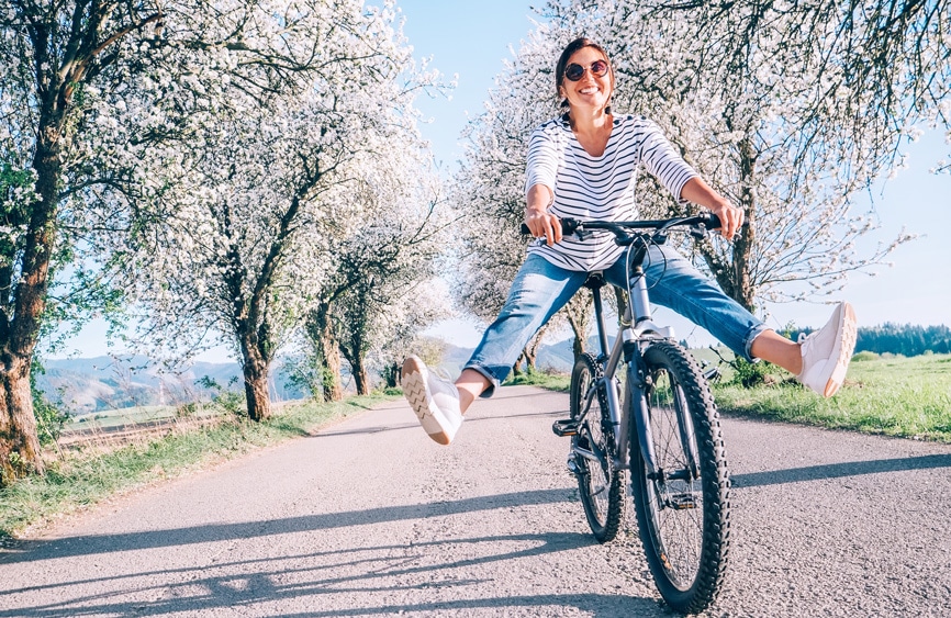 Woman biking among spring blossoms