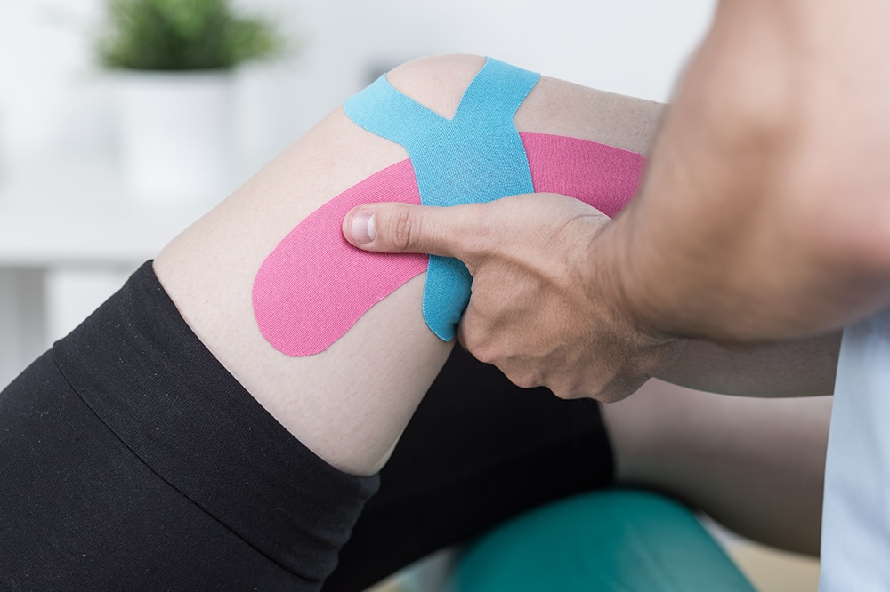 Knee with KT tape receiving PT