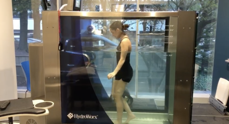 Woman in aquatic therapy treadmill
