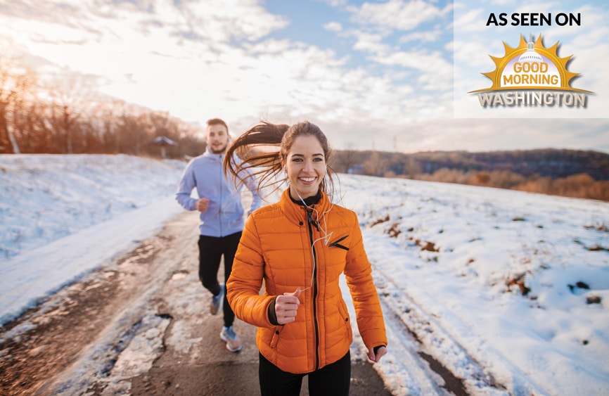 A couple running in the snow