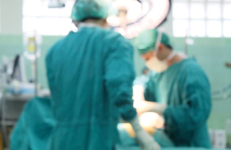 Back of two surgeons operating in the OR