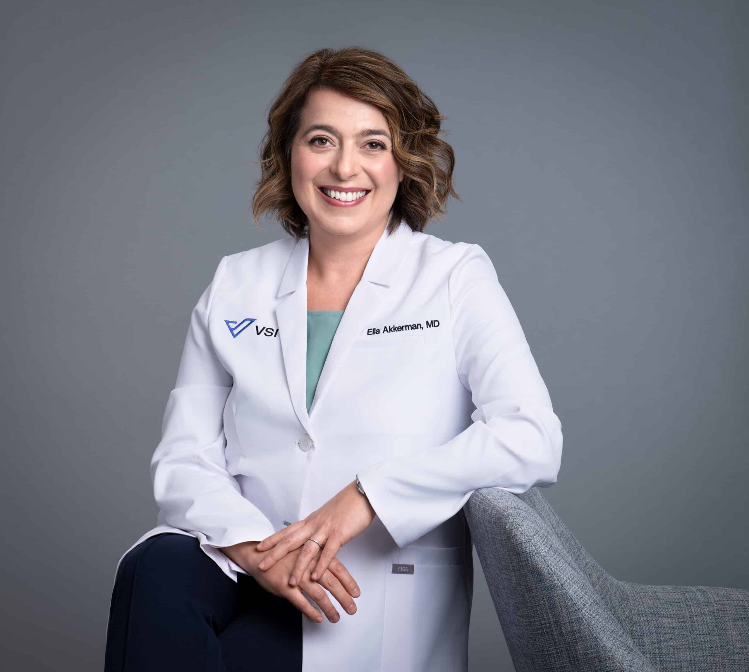 female doctor leaning on a chair