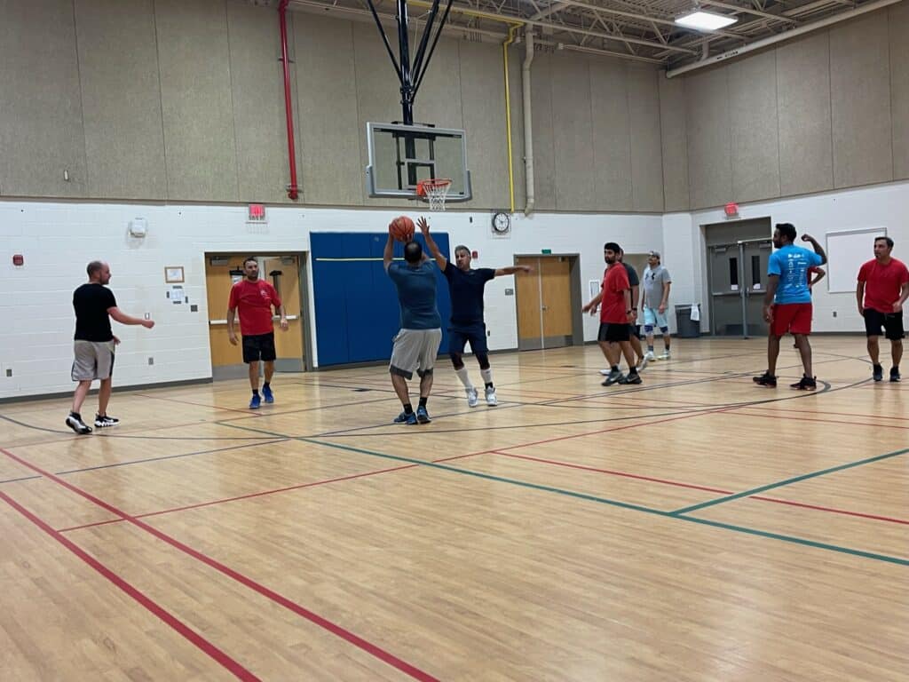 Man shooting a basketball at indoor court