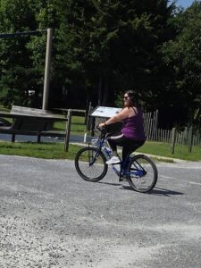 Parent riding a bike after back pain recovery