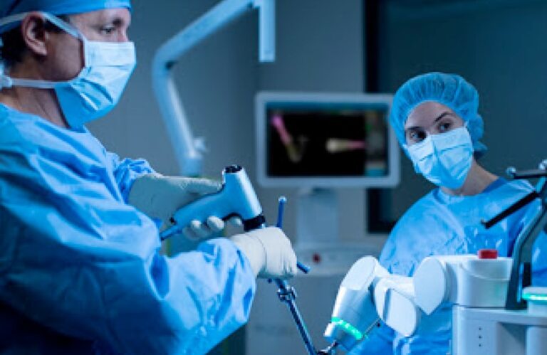 Surgeon using robotics during surgery