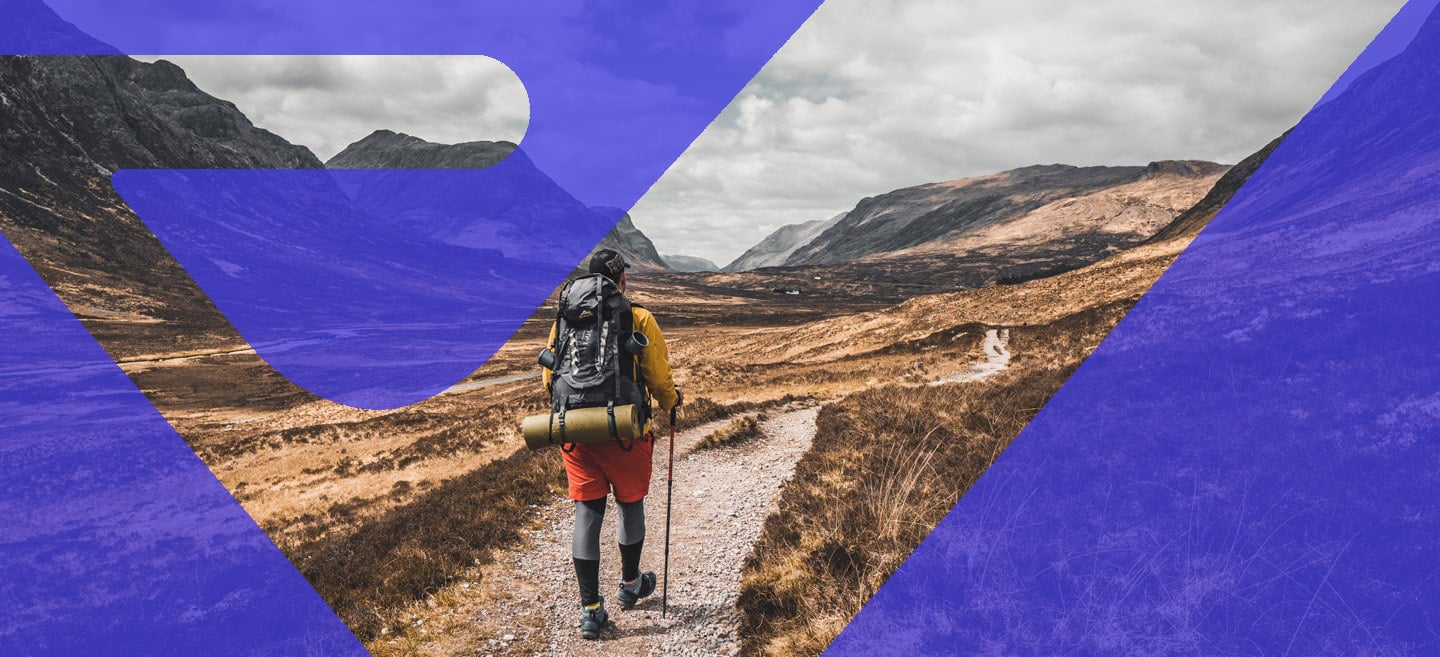 hiker hiking a gravel trail in a valley