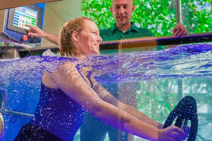Young female doing physical therapy in aquatic treadmill