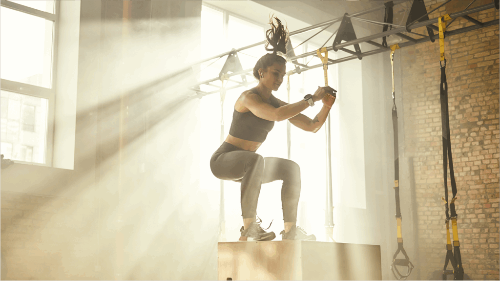 woman jumping on a block in gym