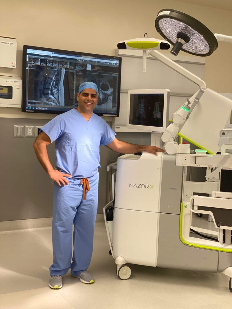 Doctor in front of robotics spine surgery system