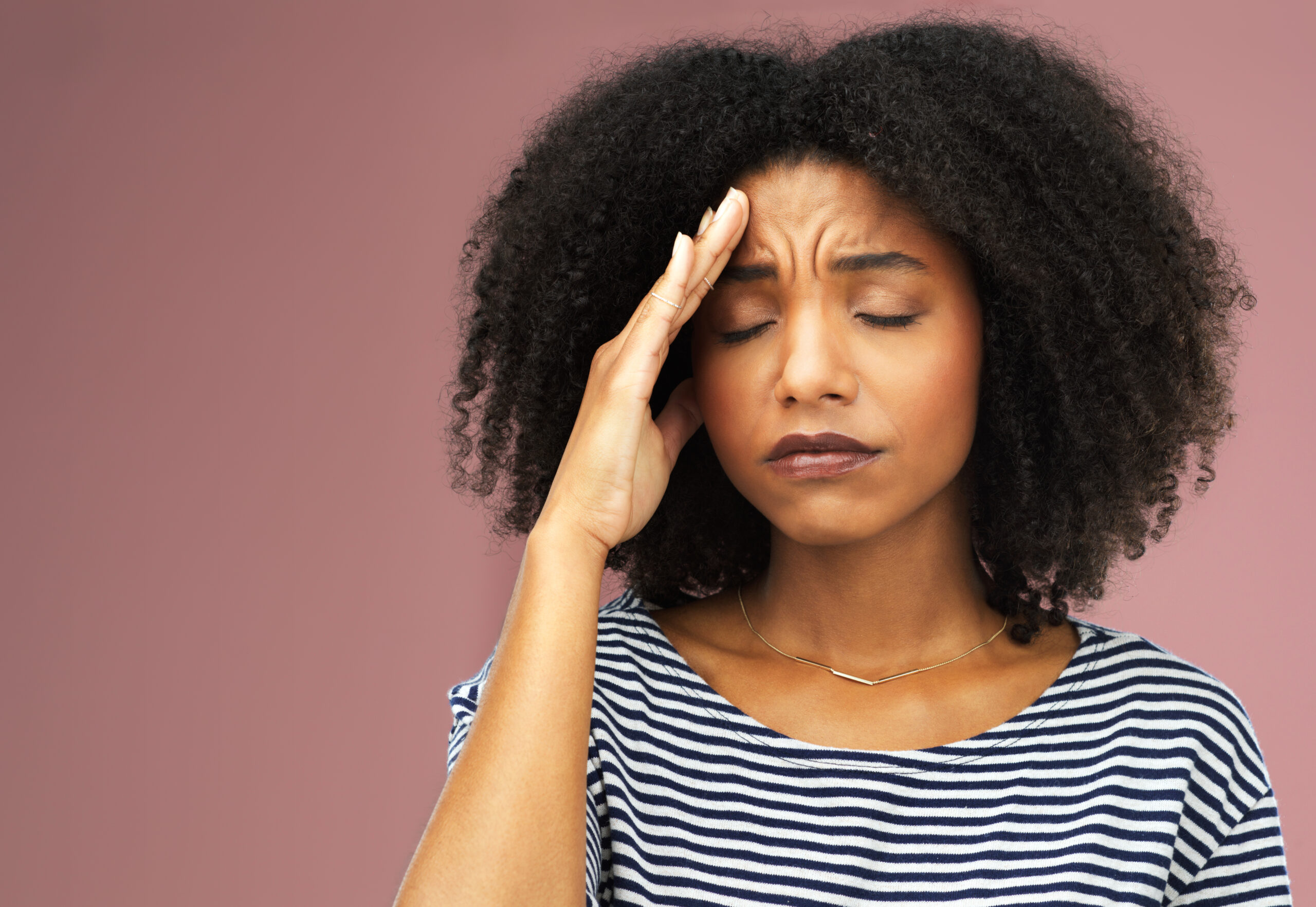 Woman gripping her head ache