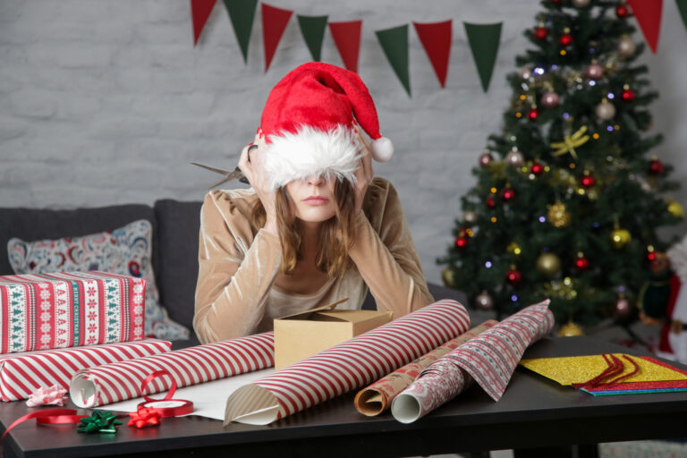 Woman wrapping gifts and overwhelmed