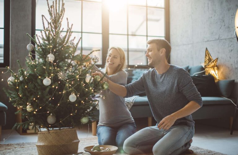 Couple decorating their Christmas tree