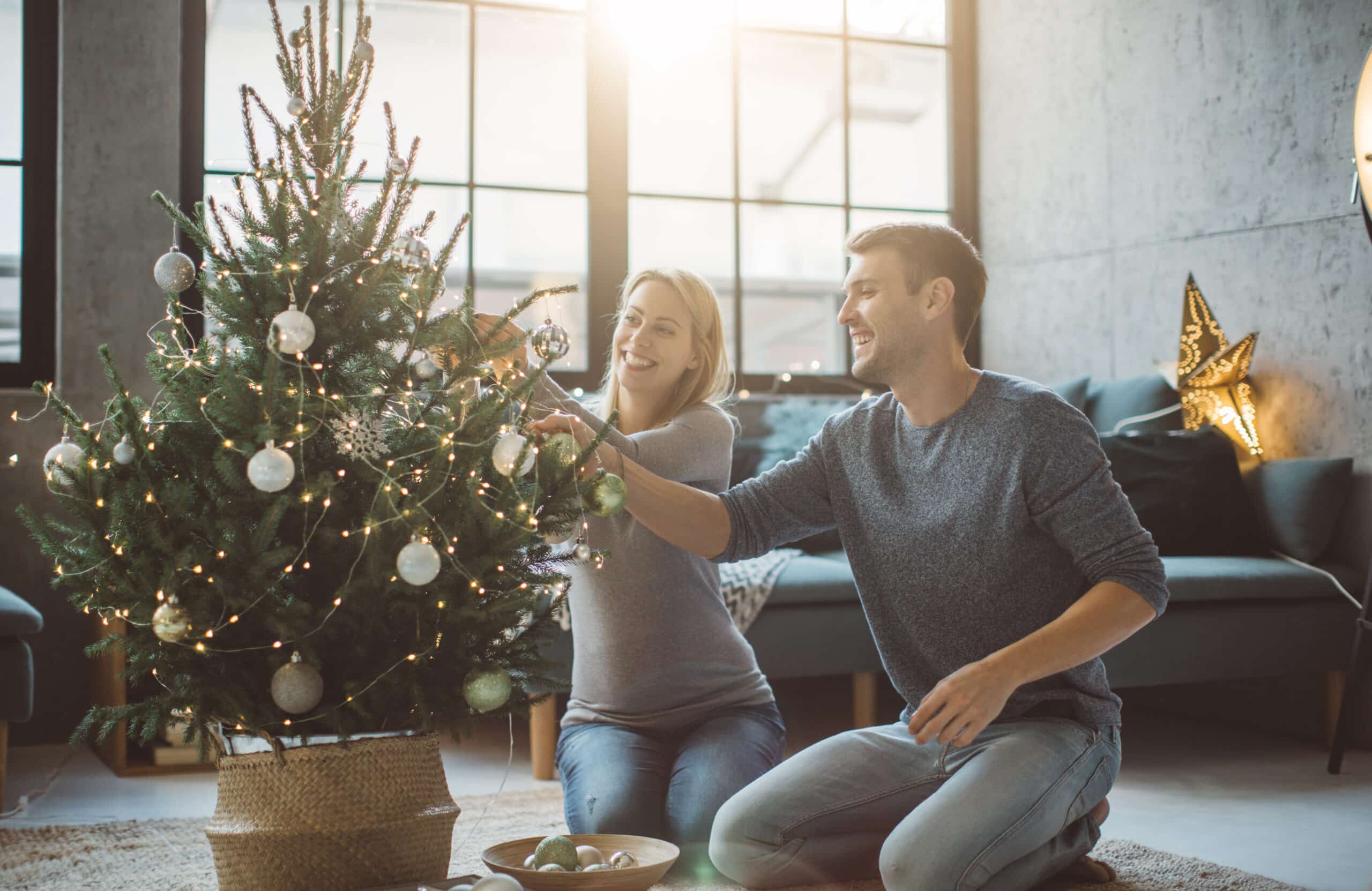 Couple decorating their Christmas tree