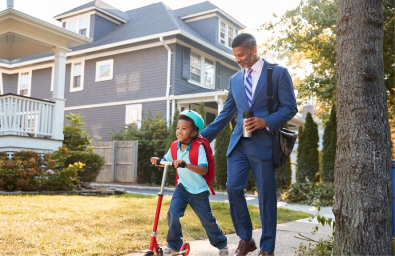 Dad in suit and son on scooter