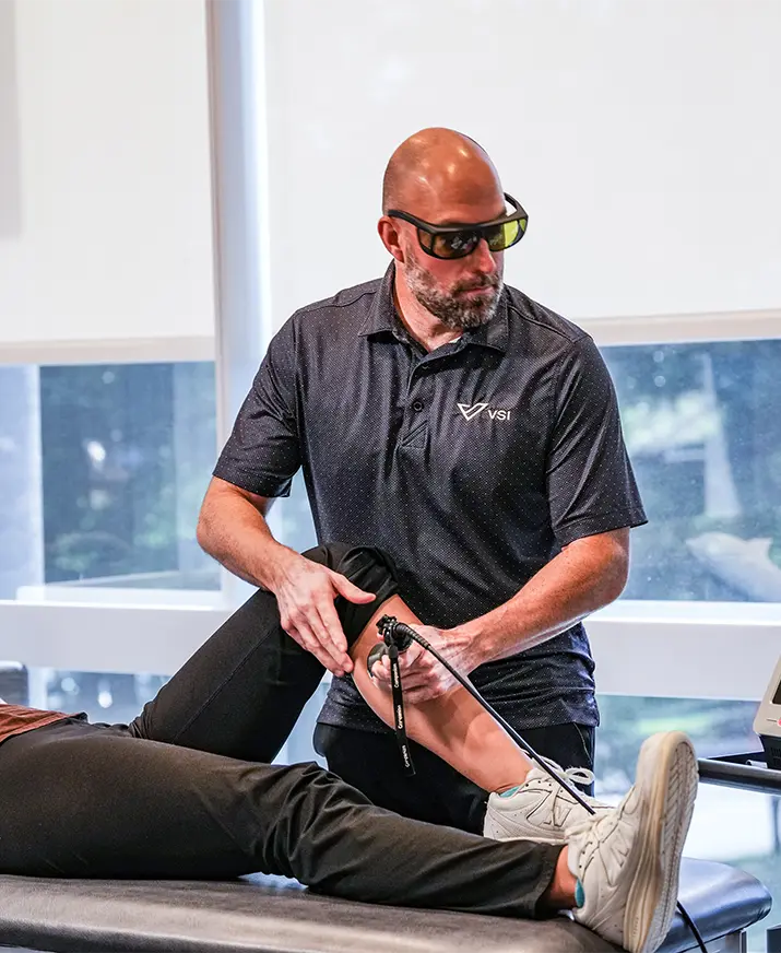 physical therapist doing laser therapy