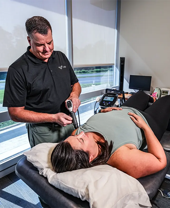 physical therapist doing shockwave therapy