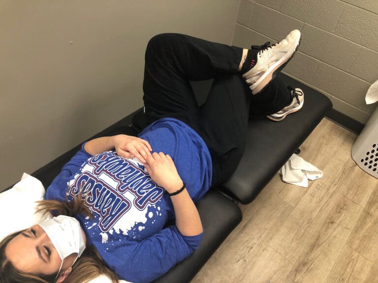 woman laying down getting physical therapy