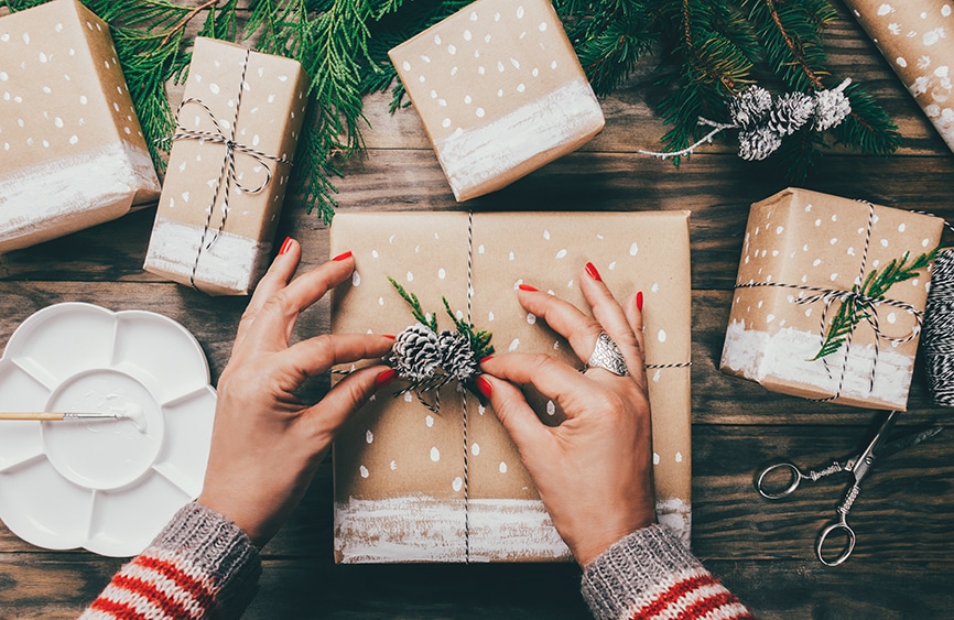 woman's hands wrapping Christmas gifts
