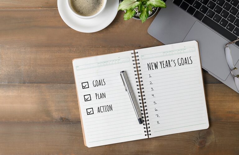 New Year's goals on a list with a laptop and coffee