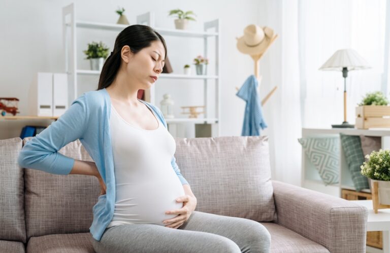 pregnant woman sitting with lower back pain