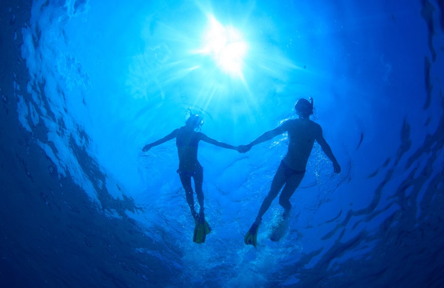 Silhouette of two swimmers