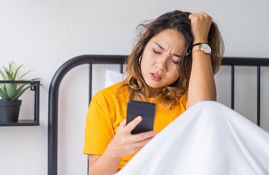Woman with a headache in bed