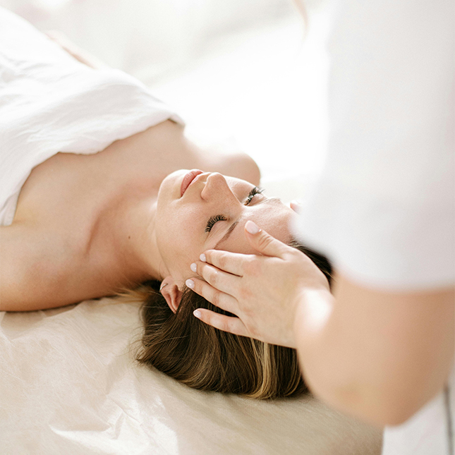 woman lying down having massage therapy for cervical neck