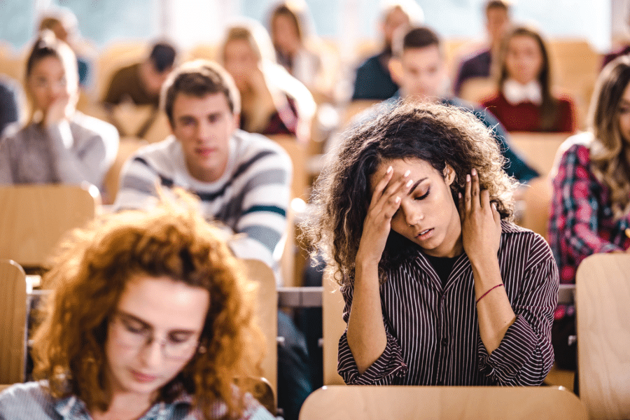 woman with migraine in class